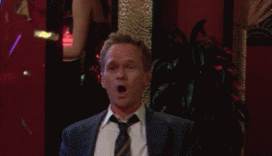 Barney from How I Met Your Mother clapping excitedly whilst confetti rains down around him.